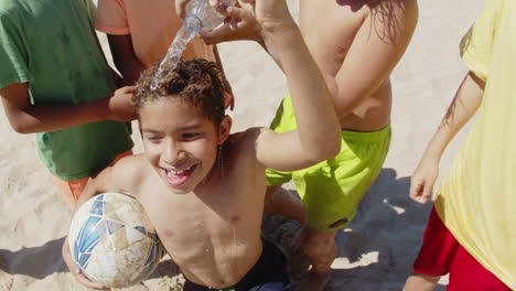 Close-up-shot-of-kids-pouring-water-on-friends-head-from-bottle